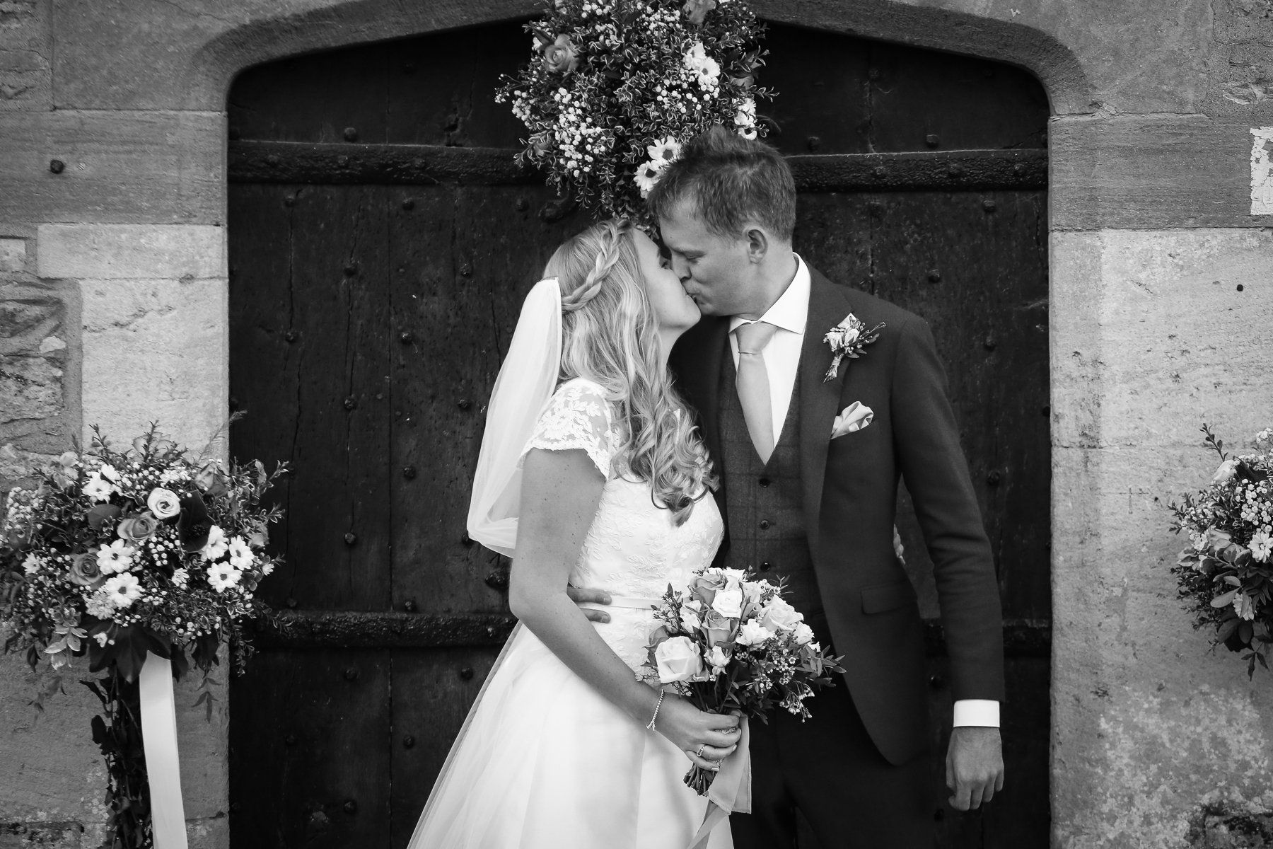bride and groom kiss in doorway of appleton church