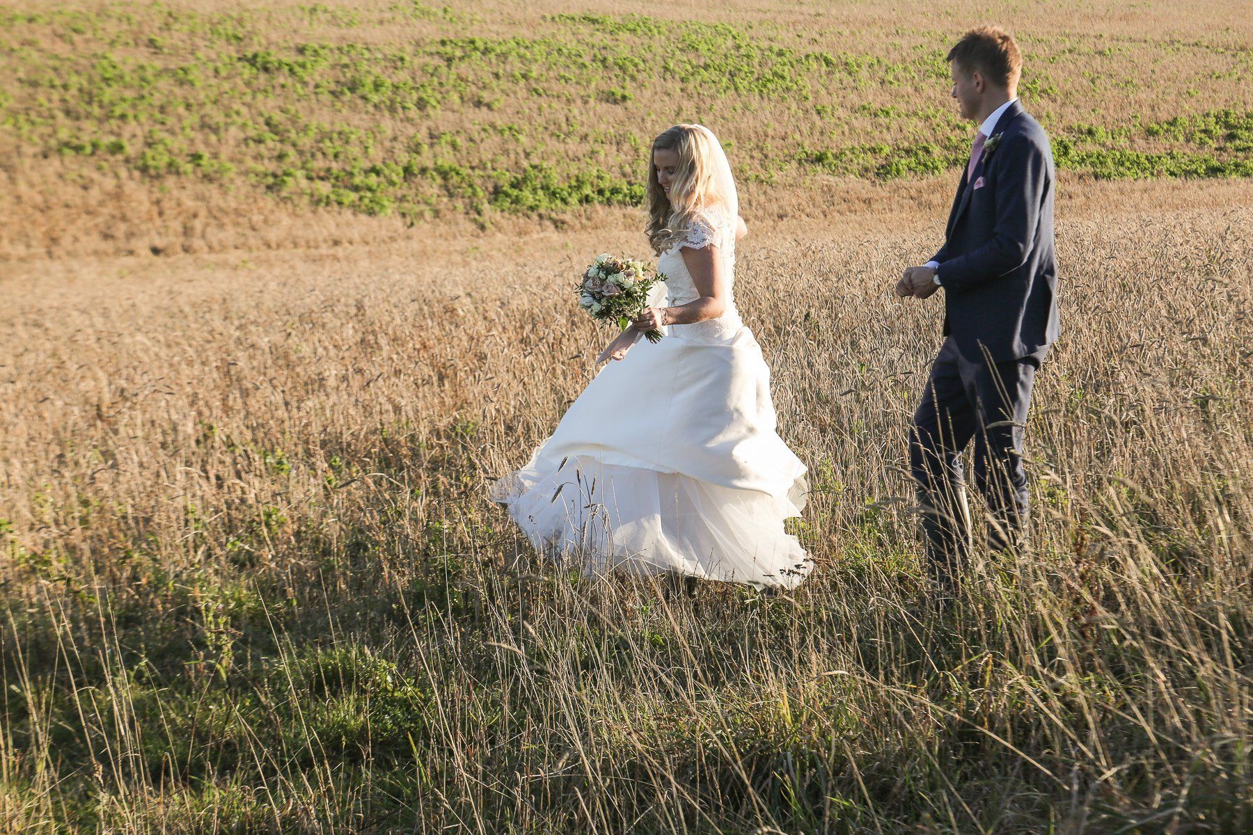 bride and groom at stone barn