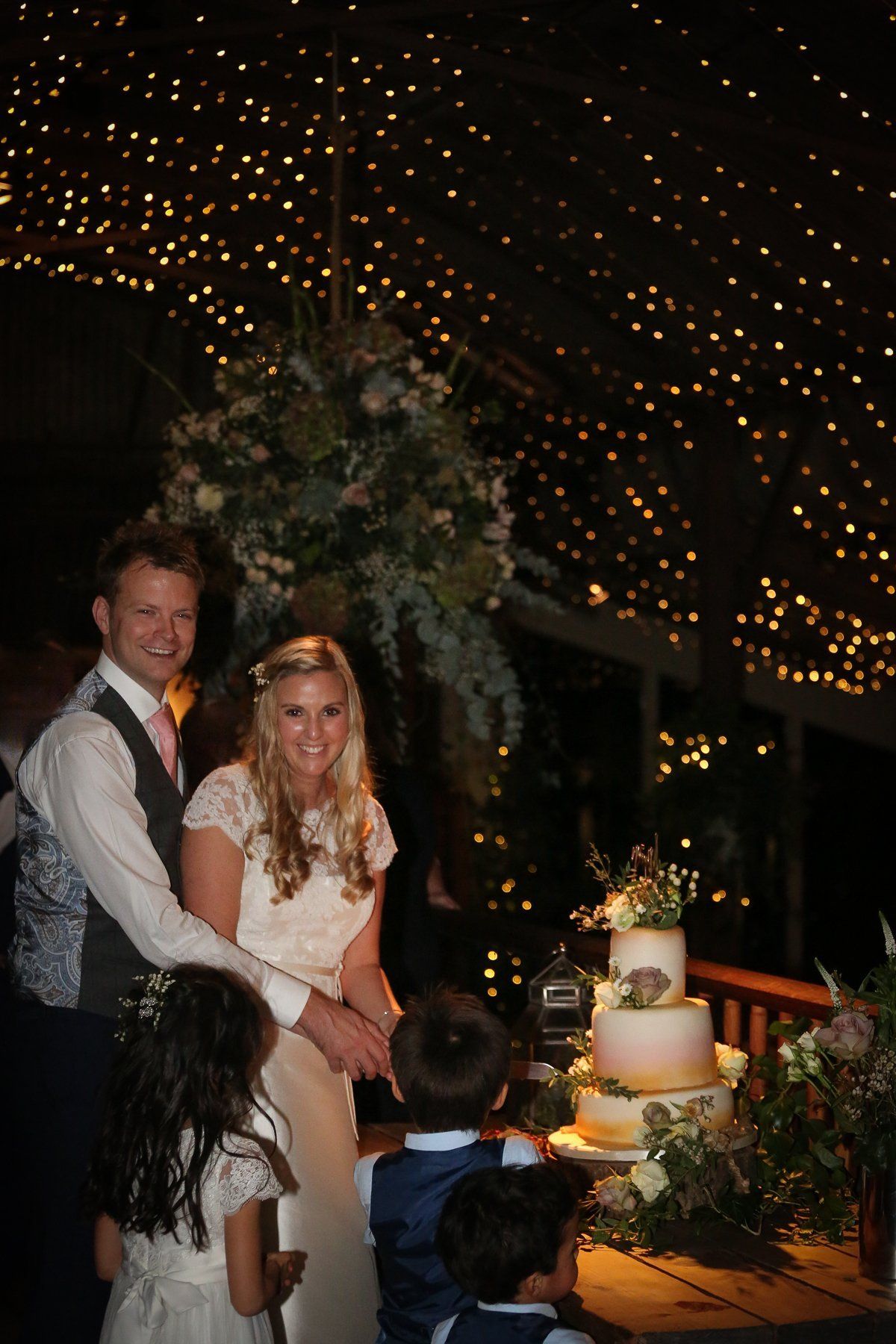 bride and groom cutting cake at cripps stone barn