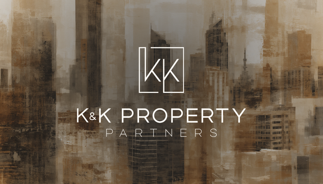 The K&K Property Partners logo in white text and line art, centered over a faded, sepia-toned city skyline.