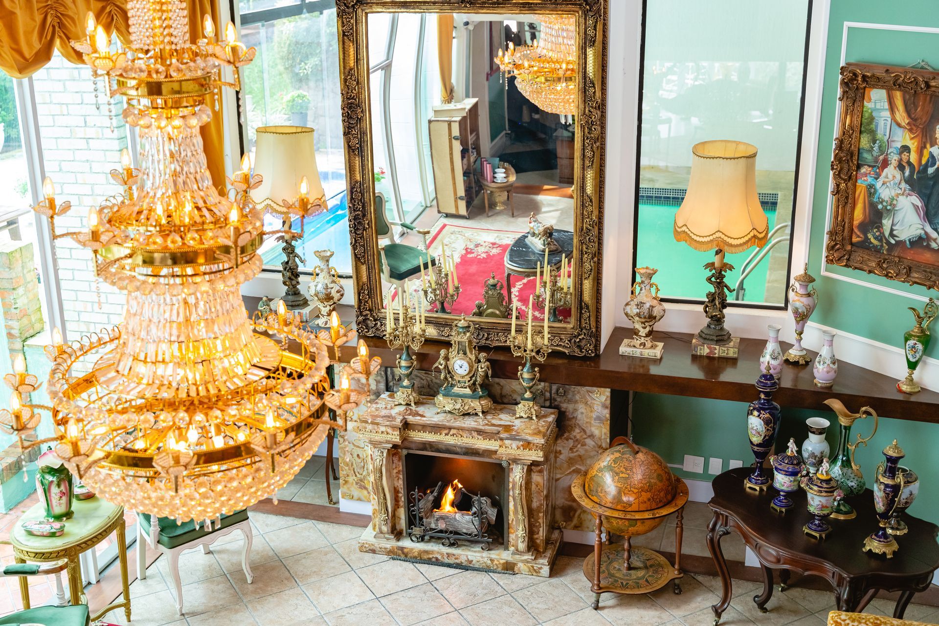 Há uma lareira no meio da sala com um lustre pendurado no teto.