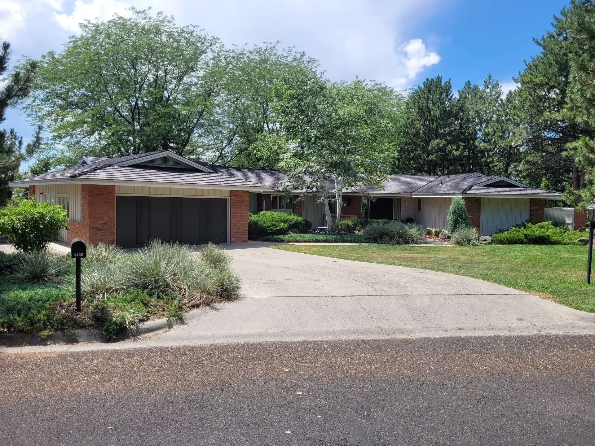 A house with a driveway and a mailbox in front of it
