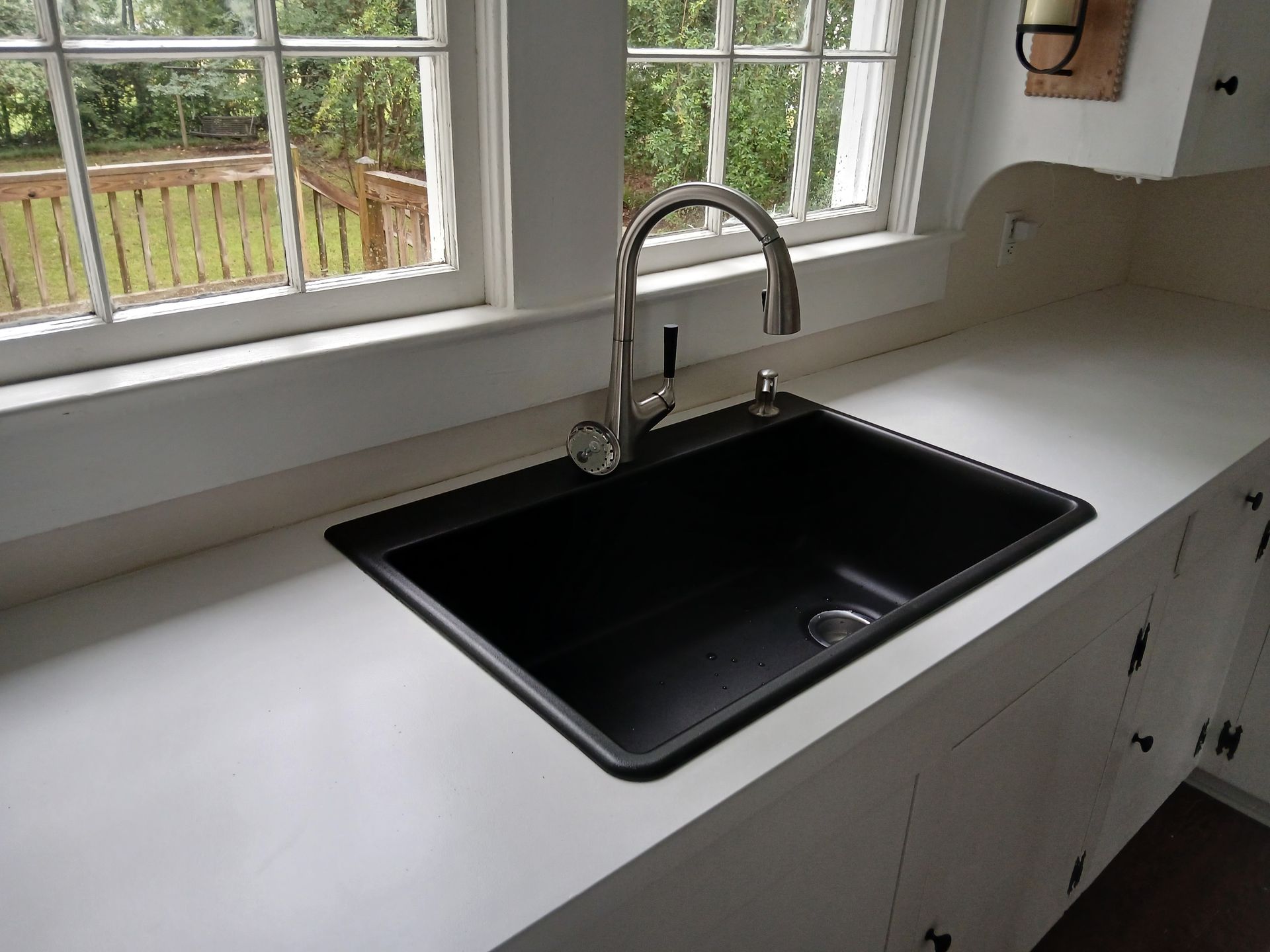 A kitchen sink with a window in the background