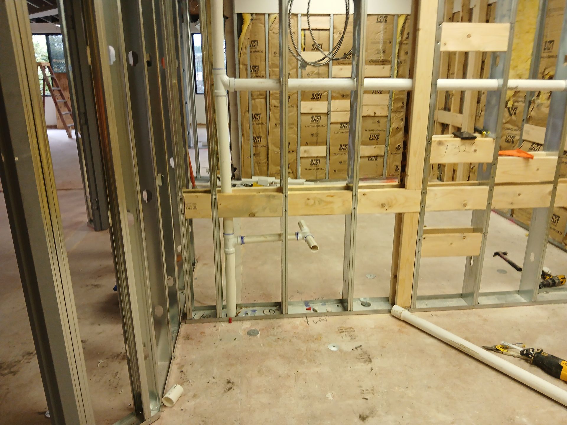 A room under construction with pipes coming out of it