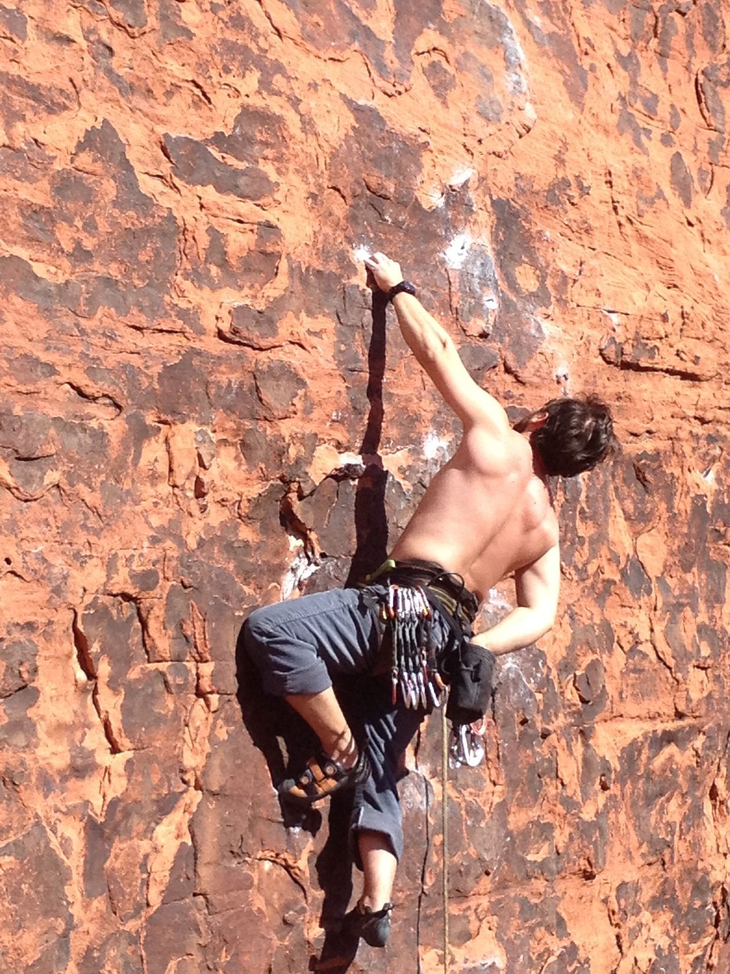 A man overcoming the challenge of rock climbing 