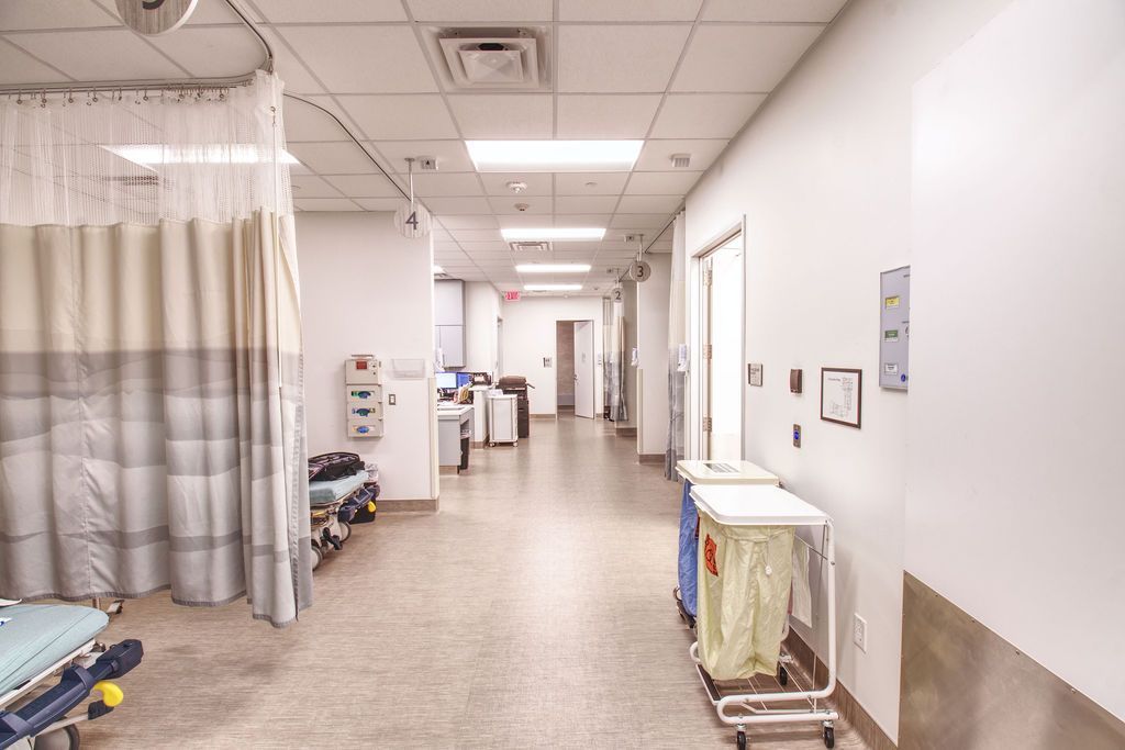 image of a ward inside the hospital separated by walls and curtains.