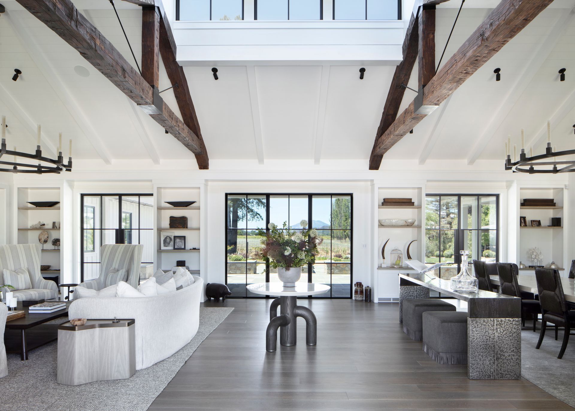 Spacious, bright living room with white walls, exposed beams remodeled by Nunley Custom Homes in Greenville, SC.