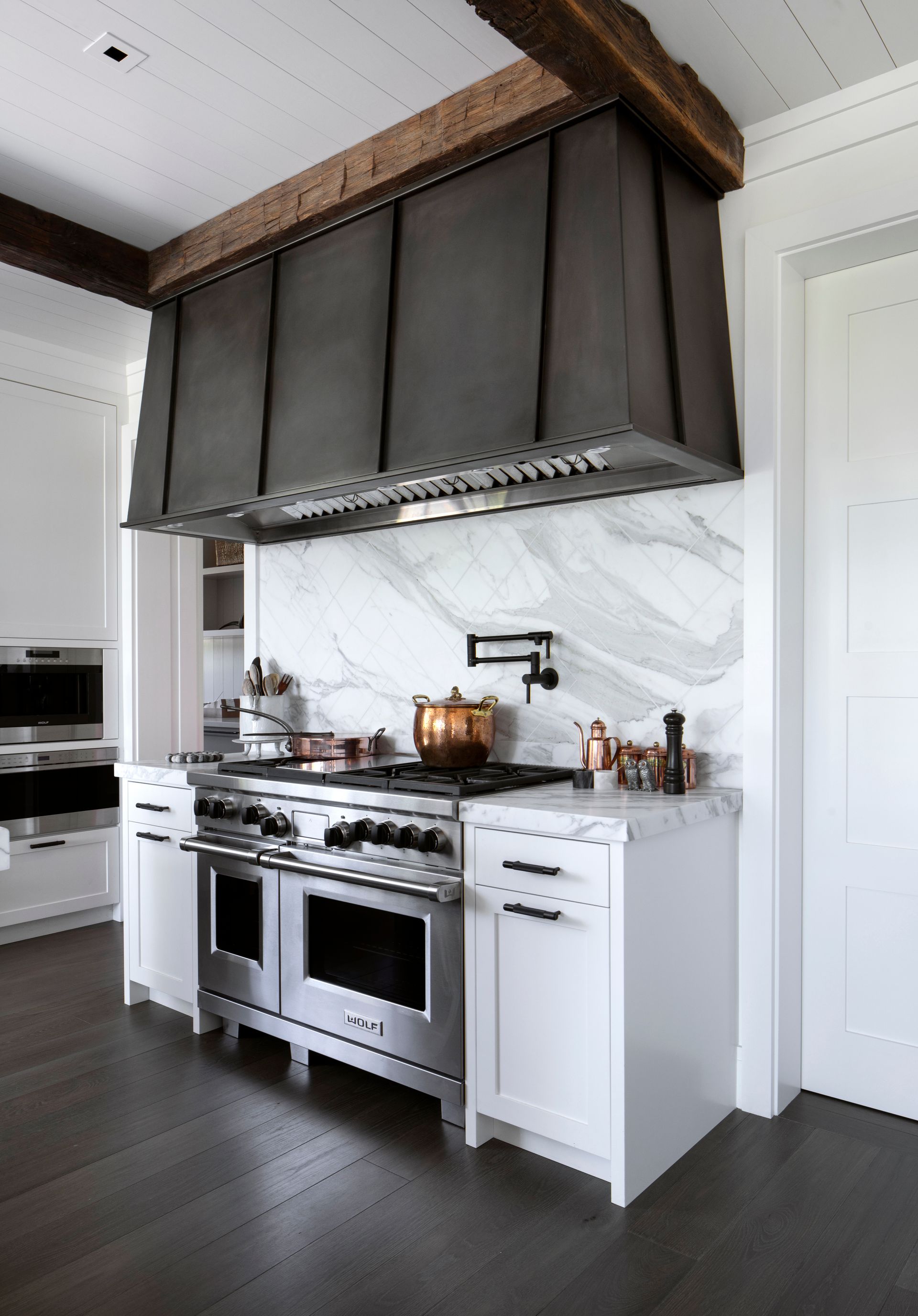 Sleek kitchen with stainless steel range, marble backsplash remodeled by Nunley Custom Homes in Greenville, SC.