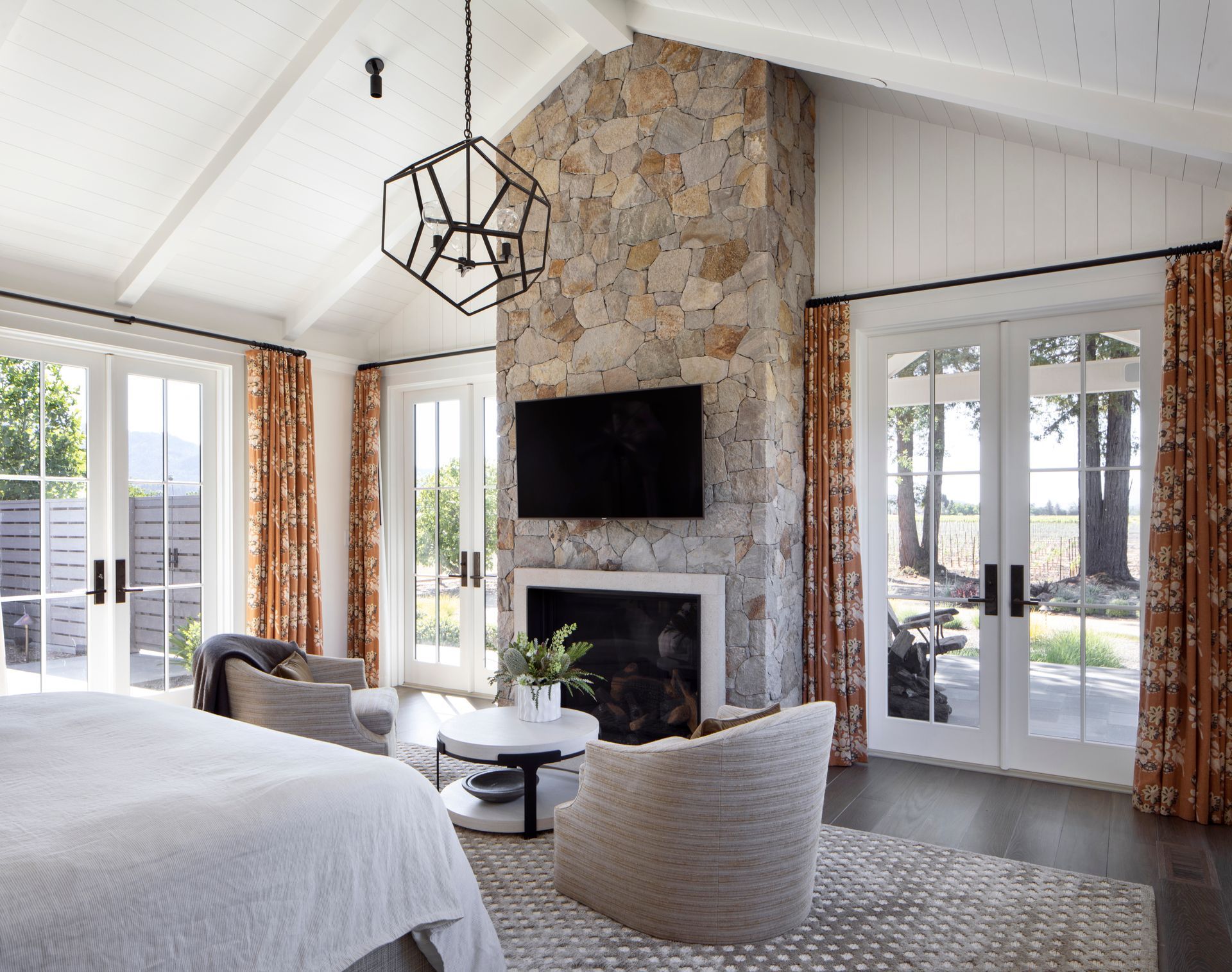 Bedroom with stone fireplace built by Nunley Custom Homes in Greenville, SC.