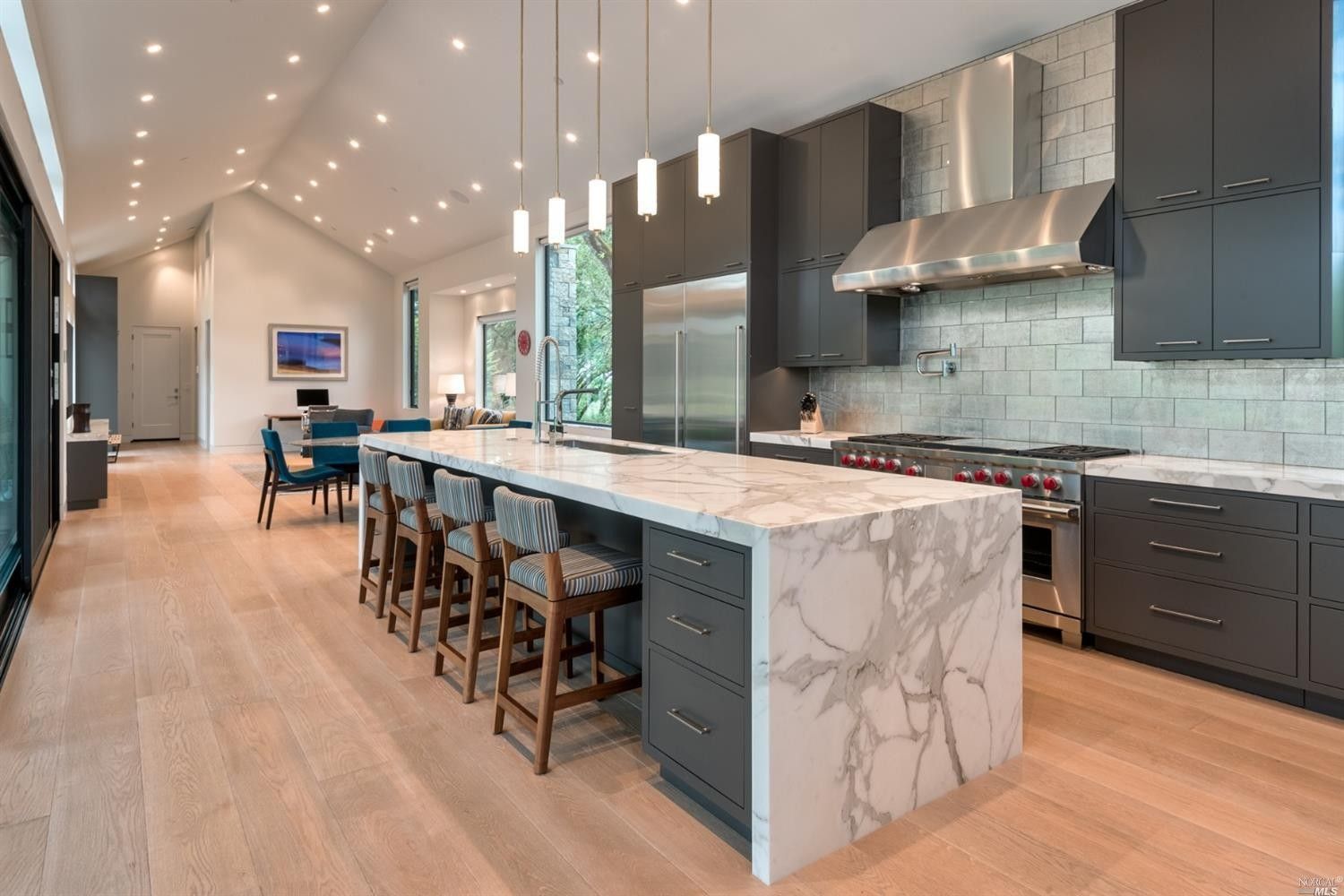 Modern kitchen with gray cabinets, marble island, and stainless steel appliances built by Nunley Custom Homes in Greenville, SC.