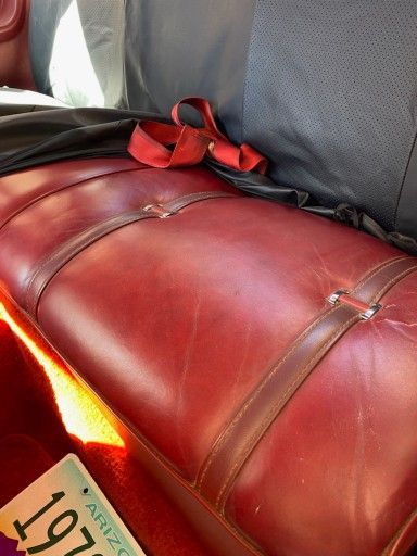 A red leather couch with a arizona license plate