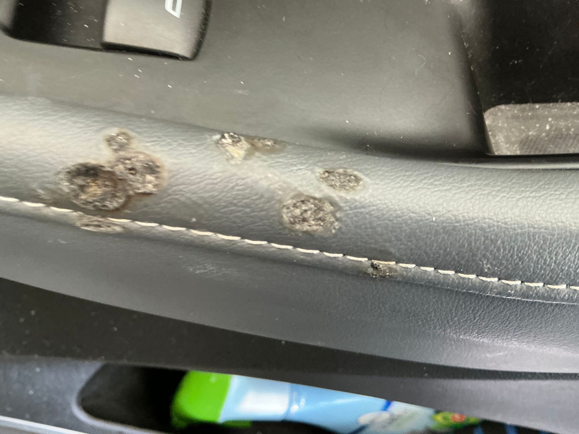 A close up of a steering wheel in a car