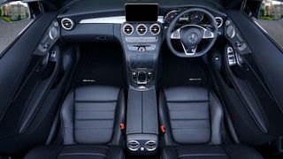 A close up of a steering wheel in a car