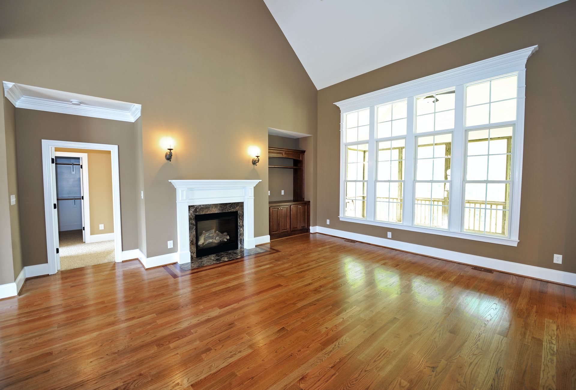 Modern living room with natural wood flooring installed, showcasing warm tones and sleek design