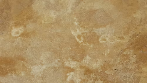 A close up of a piece of brown paper with a marble texture.