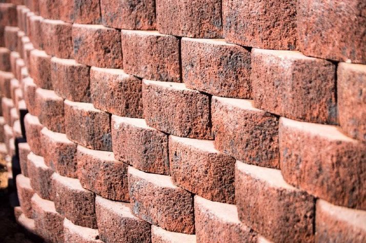 A close up of a brick wall made of red bricks.