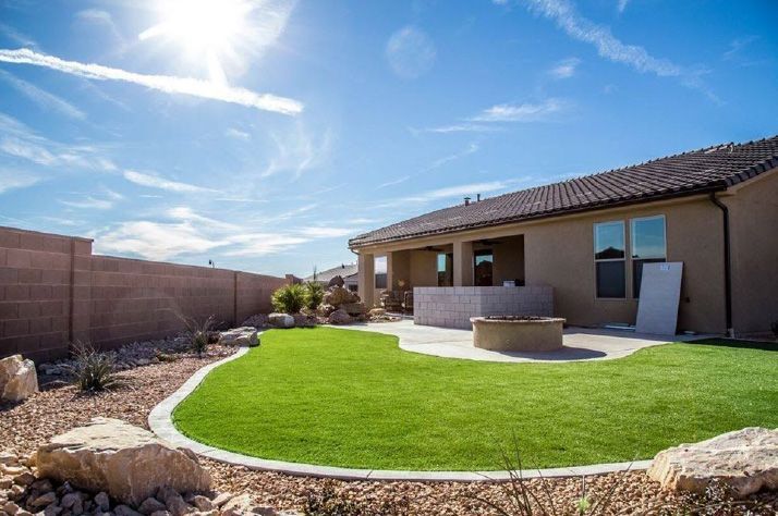 There is a fire pit in the backyard of a house.