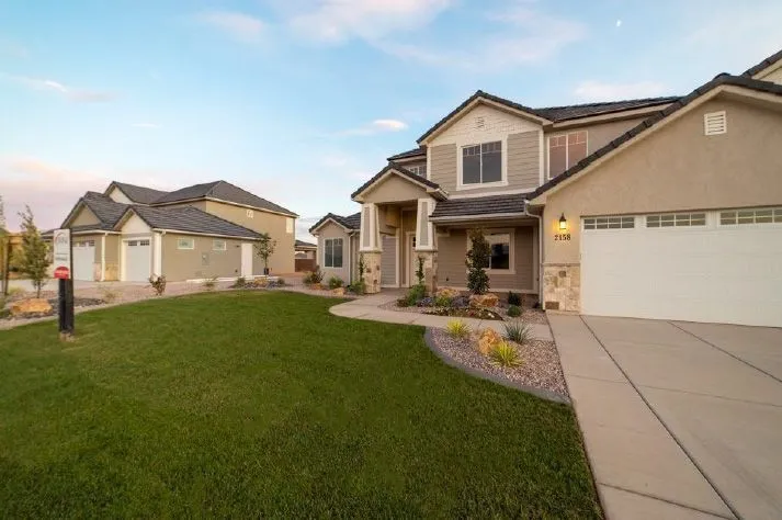 A large house with a large lawn in front of it.