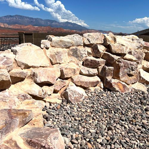 A pile of rocks with mountains in the background