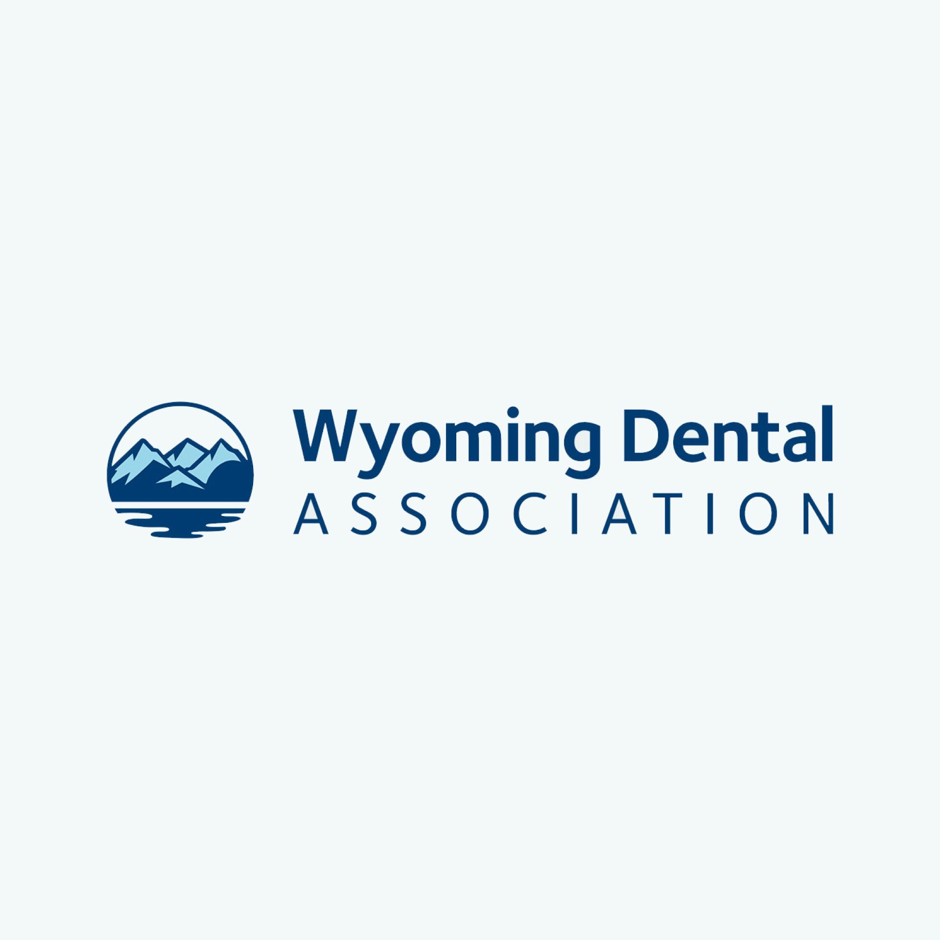 Wyoming Dental Association logo: blue mountains, water, and text on a white background.