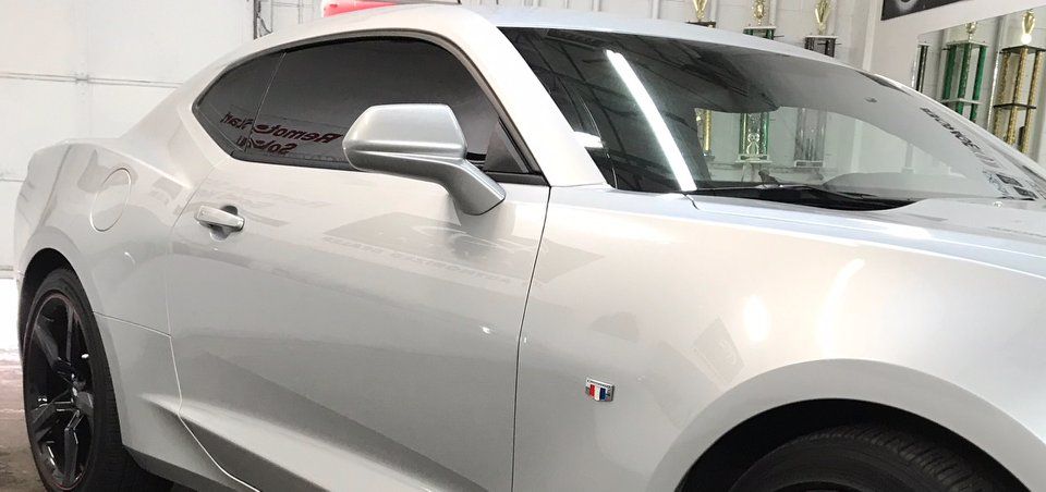 Silver Chevrolet Camaro coupe with tinted windows.