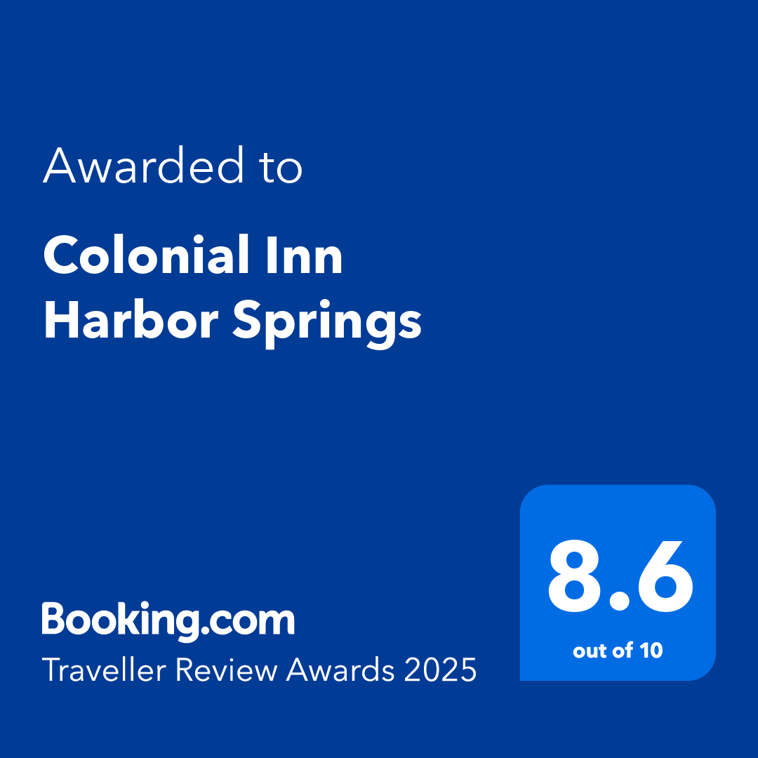 A blue sign that says `` awarded to colonial inn harbor springs ''