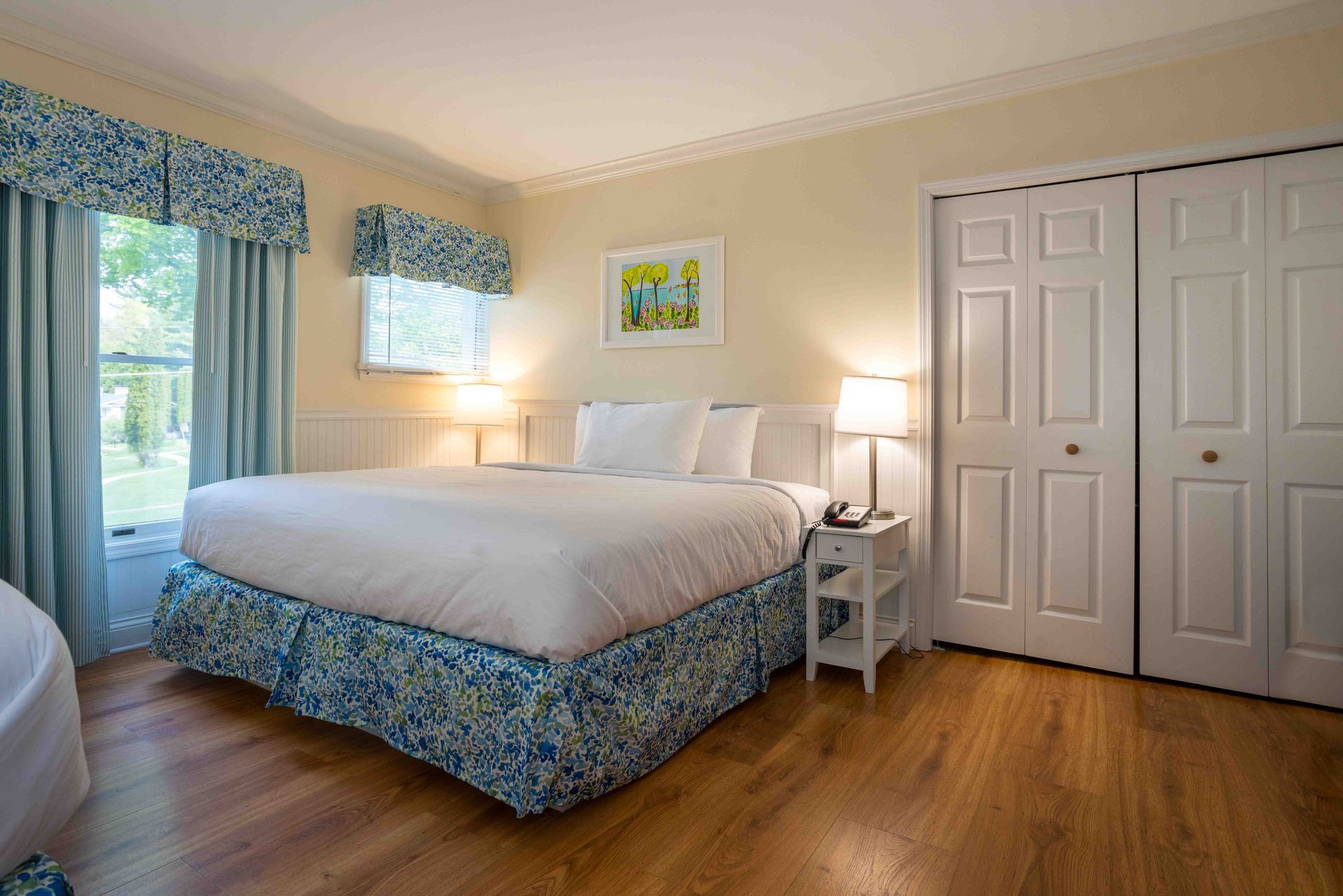 A bedroom with a king size bed and a closet.