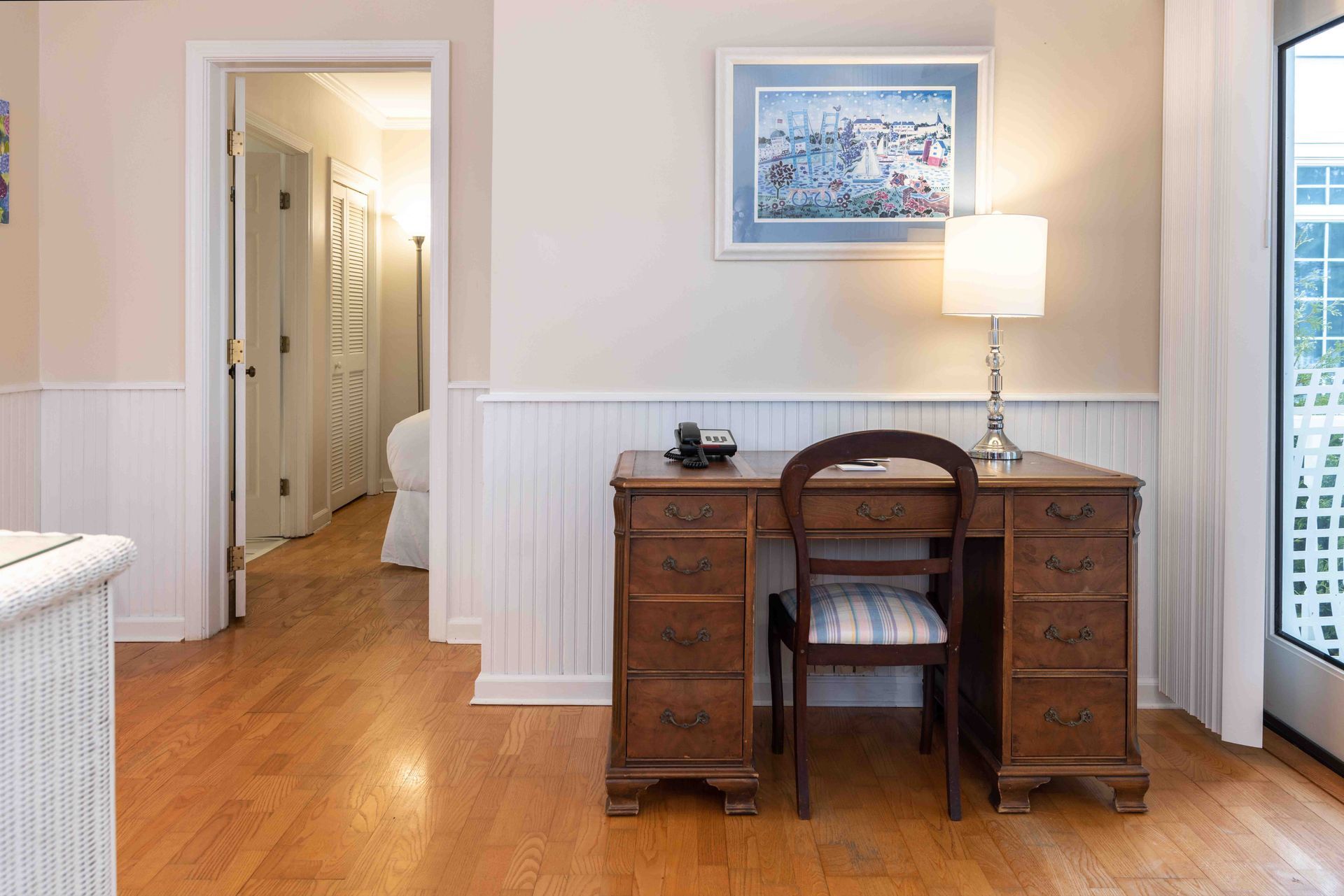 There is a desk and chair in the middle of the room.