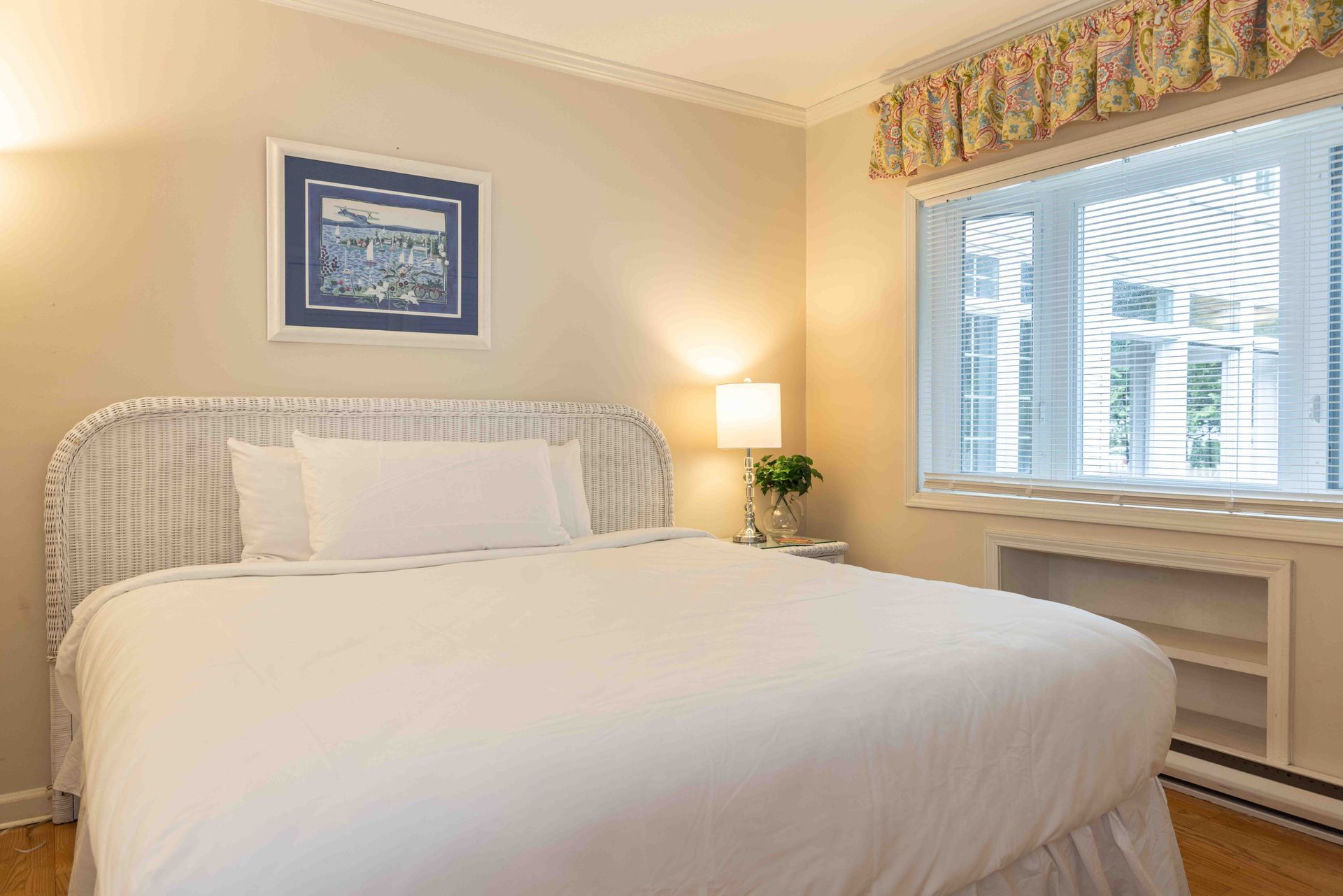 A bedroom with a king size bed and a window.