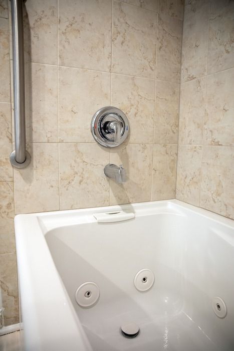 A white jacuzzi tub in a bathroom next to a shower.