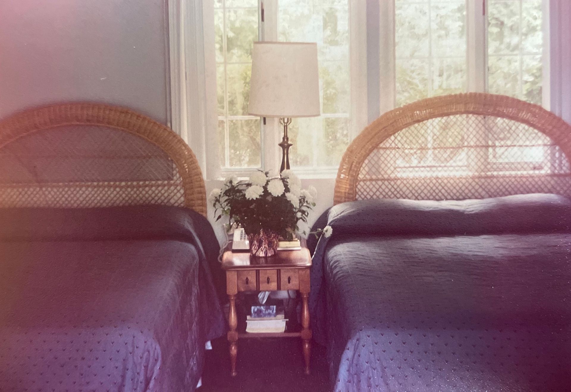 A bedroom with two twin beds and a lamp