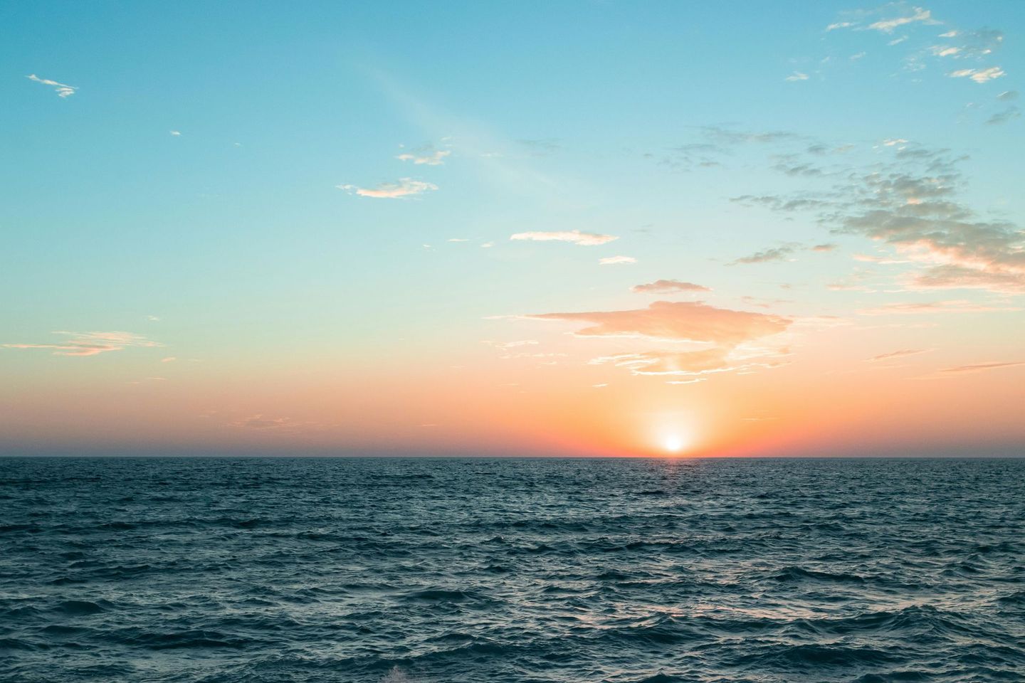 The sun is setting over the ocean.