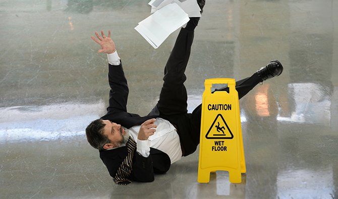 Businessman Falling on Wet Floor — Morganton, NC — Law Office of Timothy J. Rooks