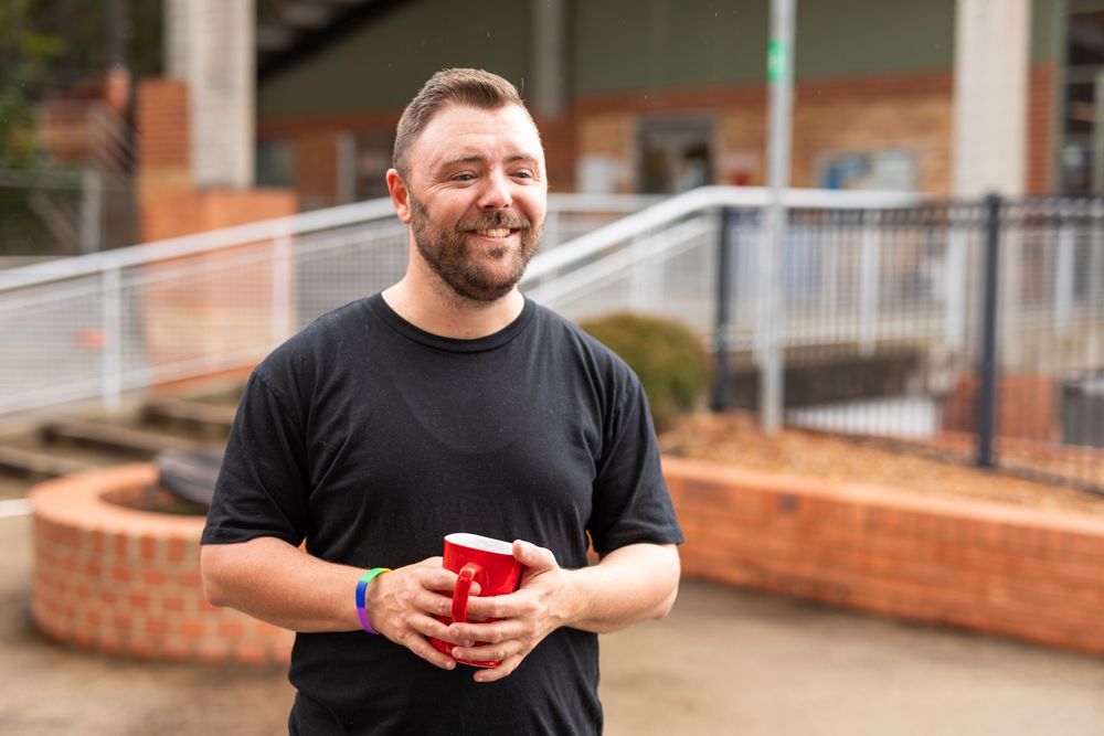 A Man Holding Red Cup — Keilor East, VIC — North West Melbourne Family Respite