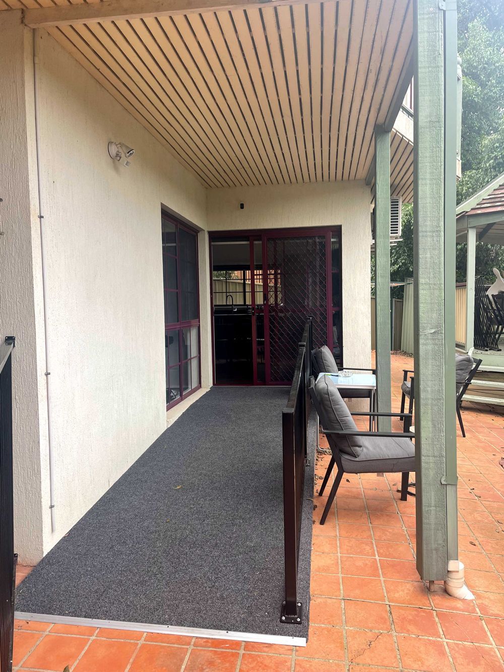 A Patio With Chairs and a Couch Under a Covered Porch — Keilor East, VIC — North West Melbourne Family Respite