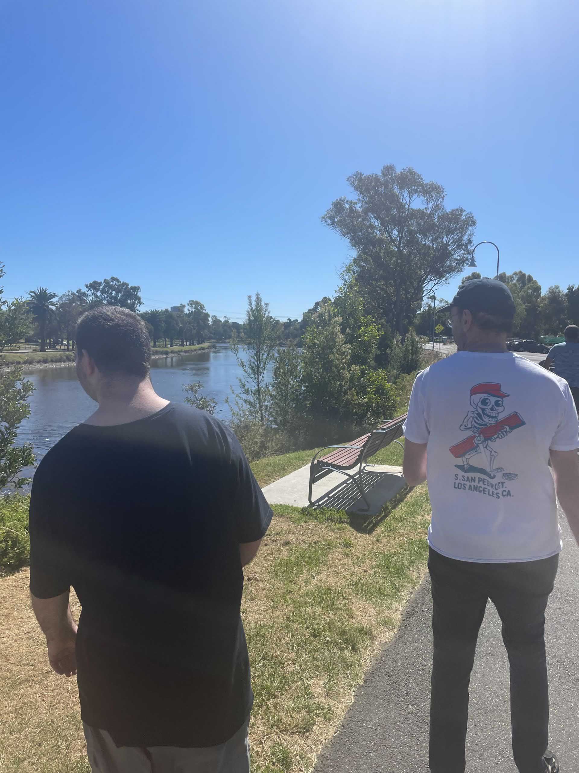 Two Men Standing Next to Each Other in Front of a Lake — Keilor East, VIC — North West Melbourne Family Respite