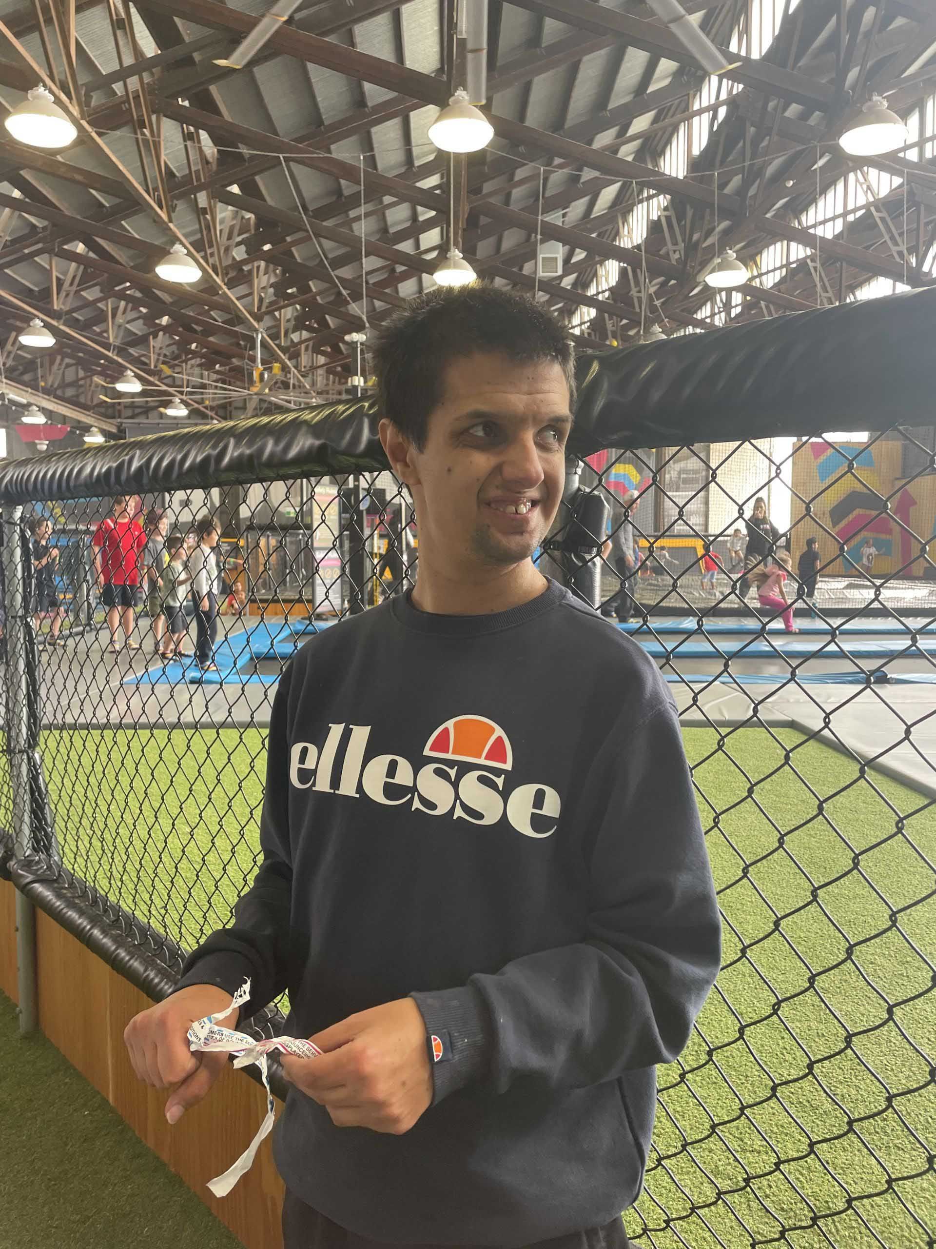 A Man Standing In Front of Tennis Court — Keilor East, VIC — North West Melbourne Family Respite