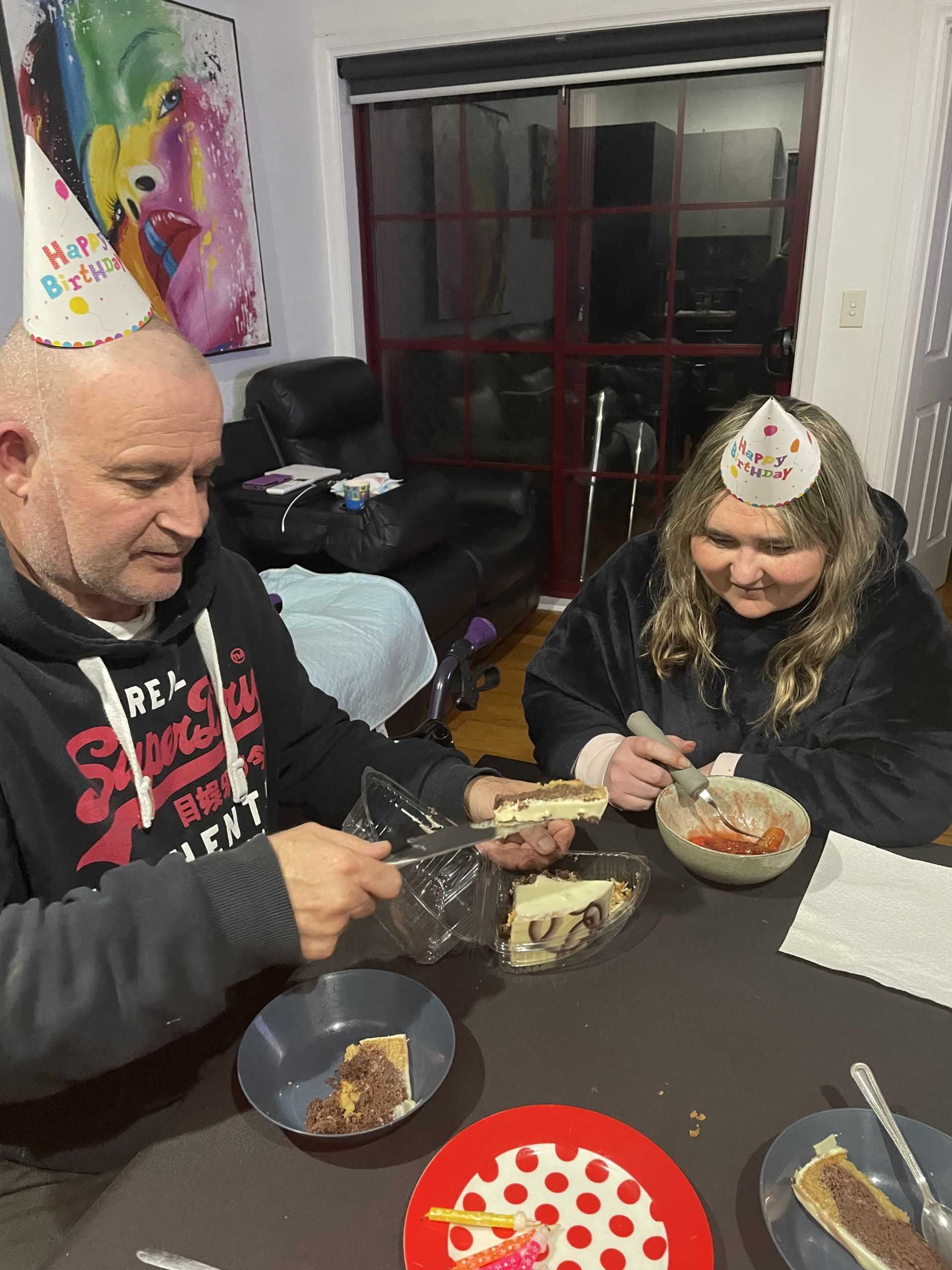 A Man and a Woman Are Sitting at a Table Eating Food — Keilor East, VIC — North West Melbourne Family Respite