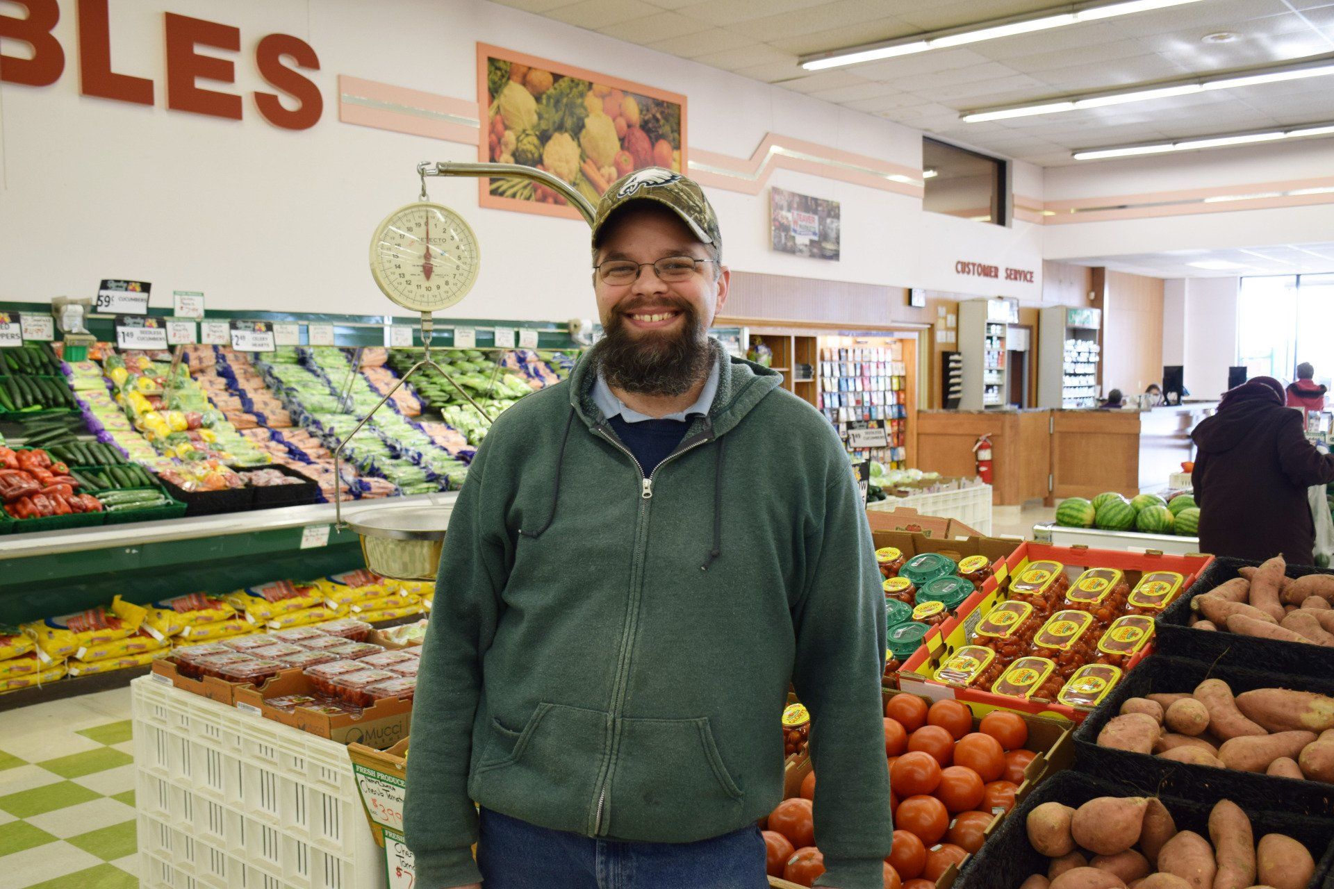 A man is standing in front of a sign that says bles