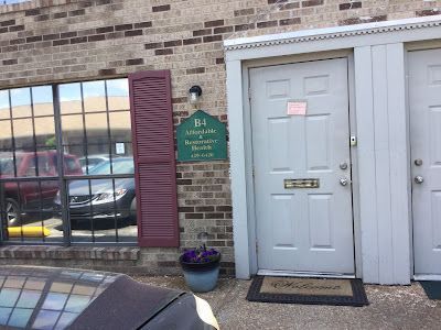 A White Door is Sitting in Front of a Brick Building