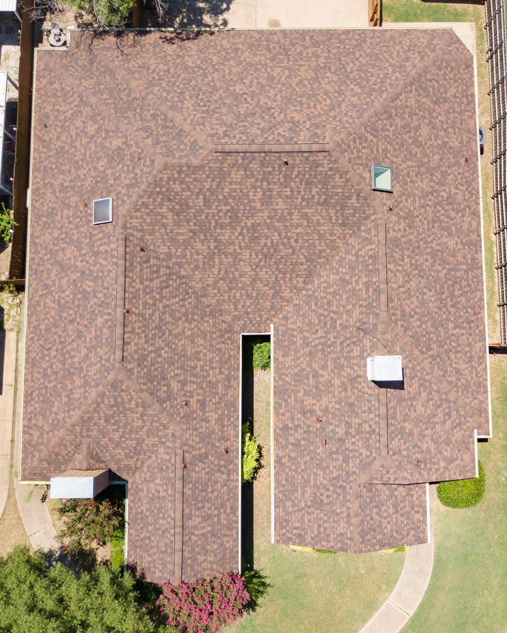an aerial view of a house with a brown roof