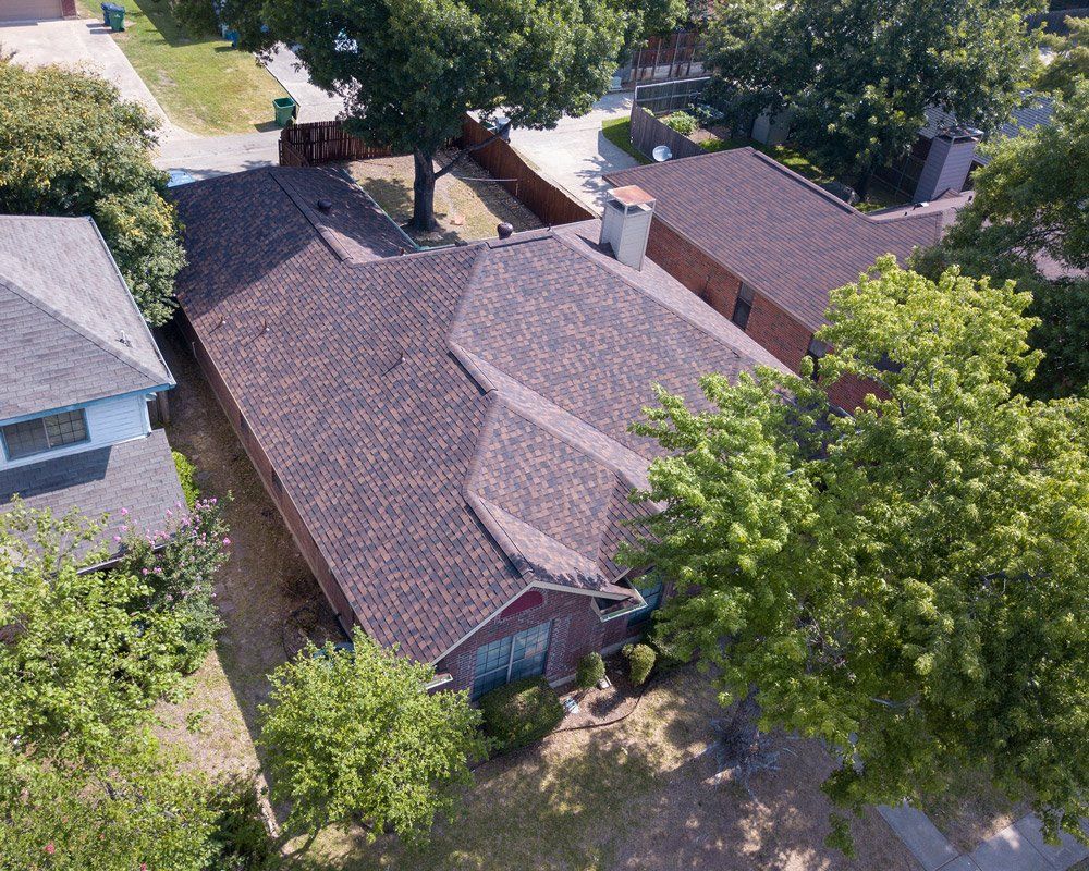 an aerial view of a house with a brown roof
