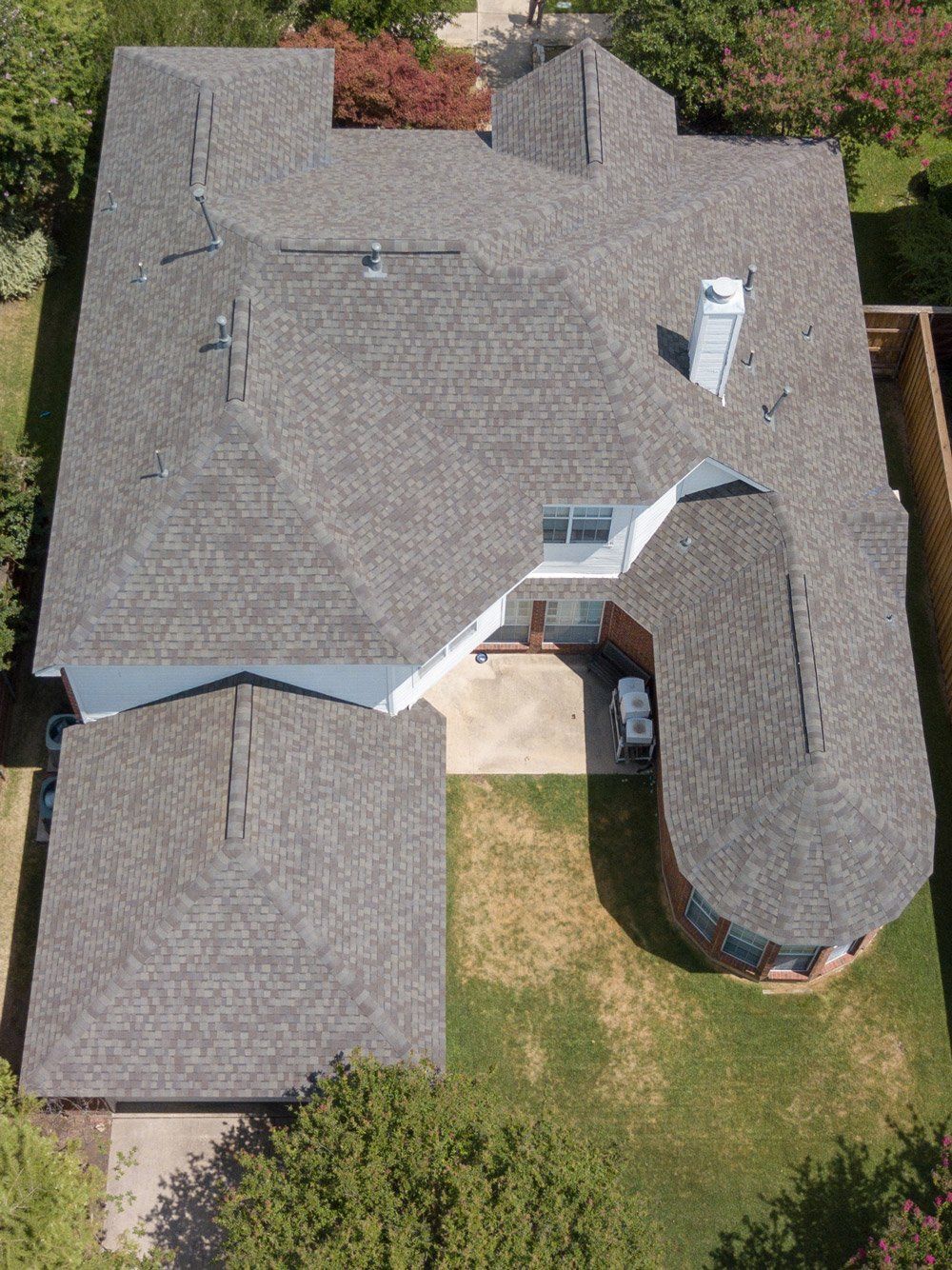 an aerial view of a house with a curved roof