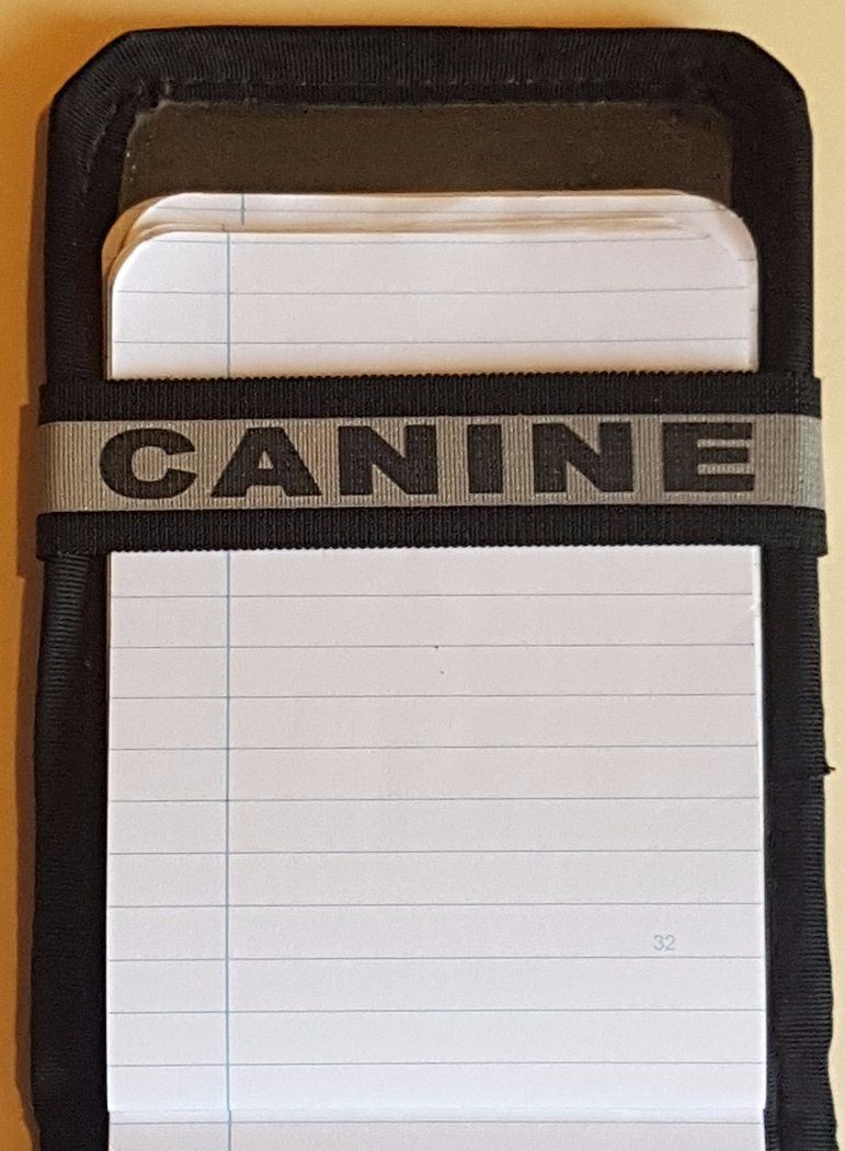 A Notebands™ for your Duty Notebook with the word canine on it