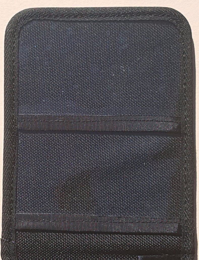 A black Duty Notebook cover with a stitched pattern on it.