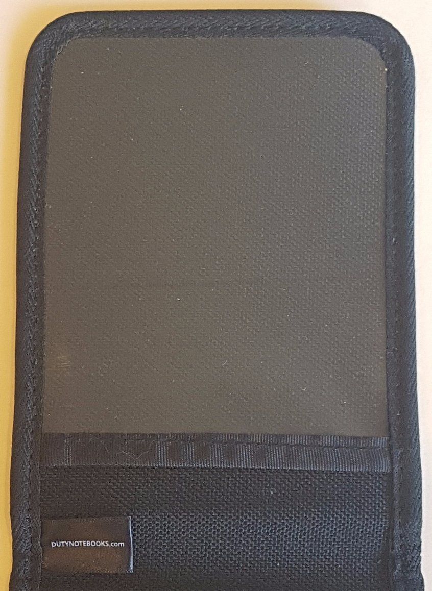 A black Duty Notebook cover with a label that says ' wallet ' on it