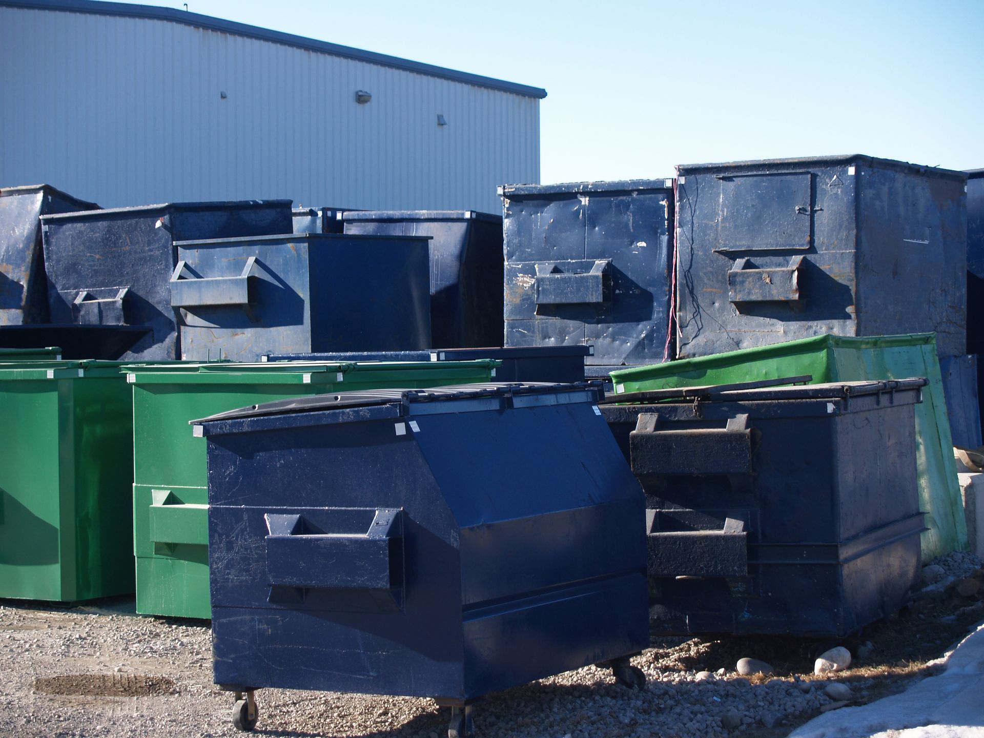A bunch of dumpsters are stacked on top of each other