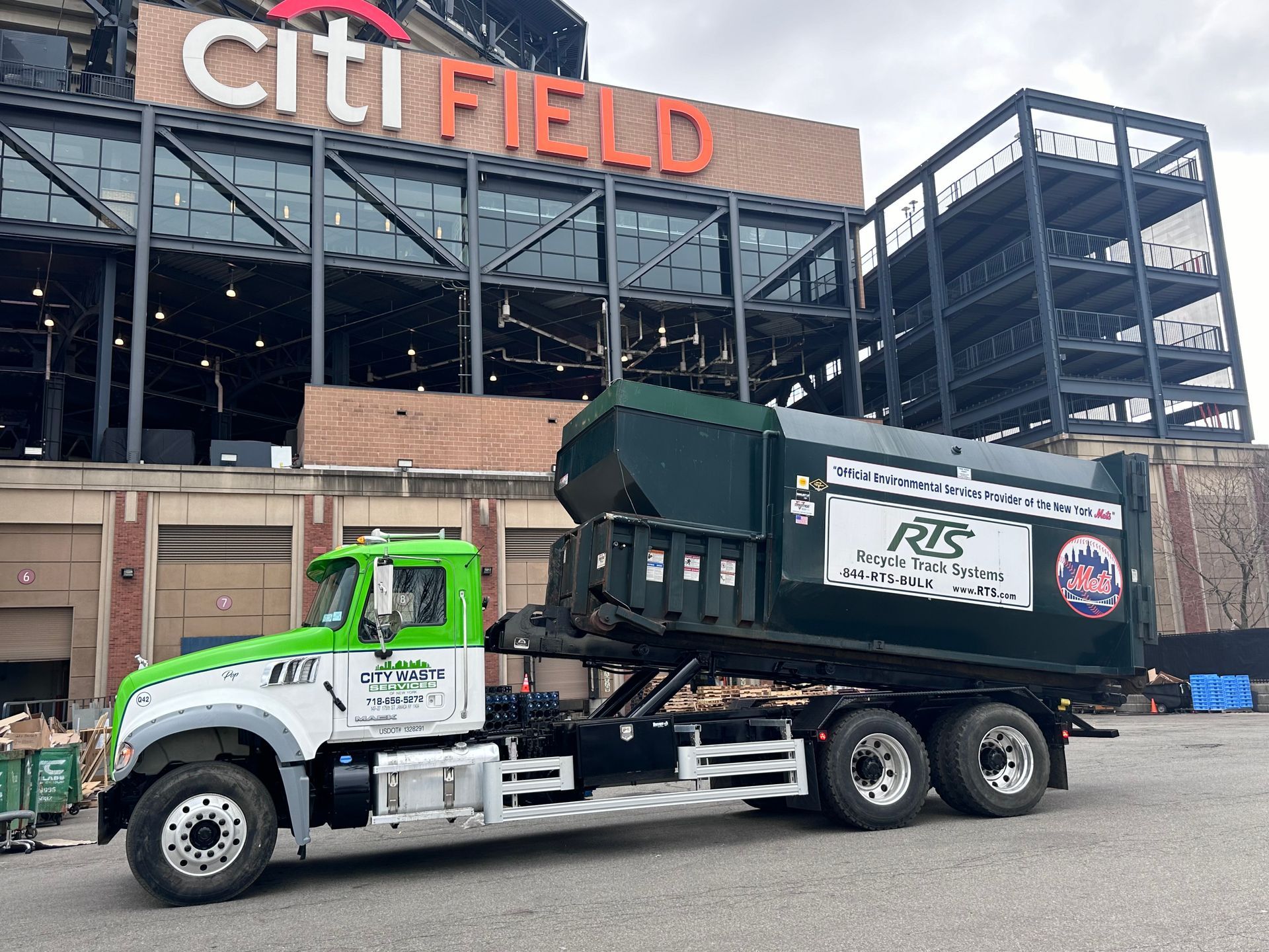 A blue semi truck is parked on the side of the road.
