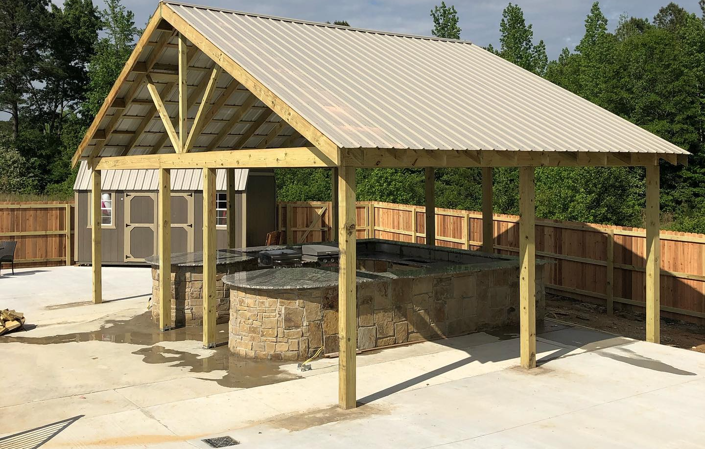 A large wooden structure with a metal roof is being built.