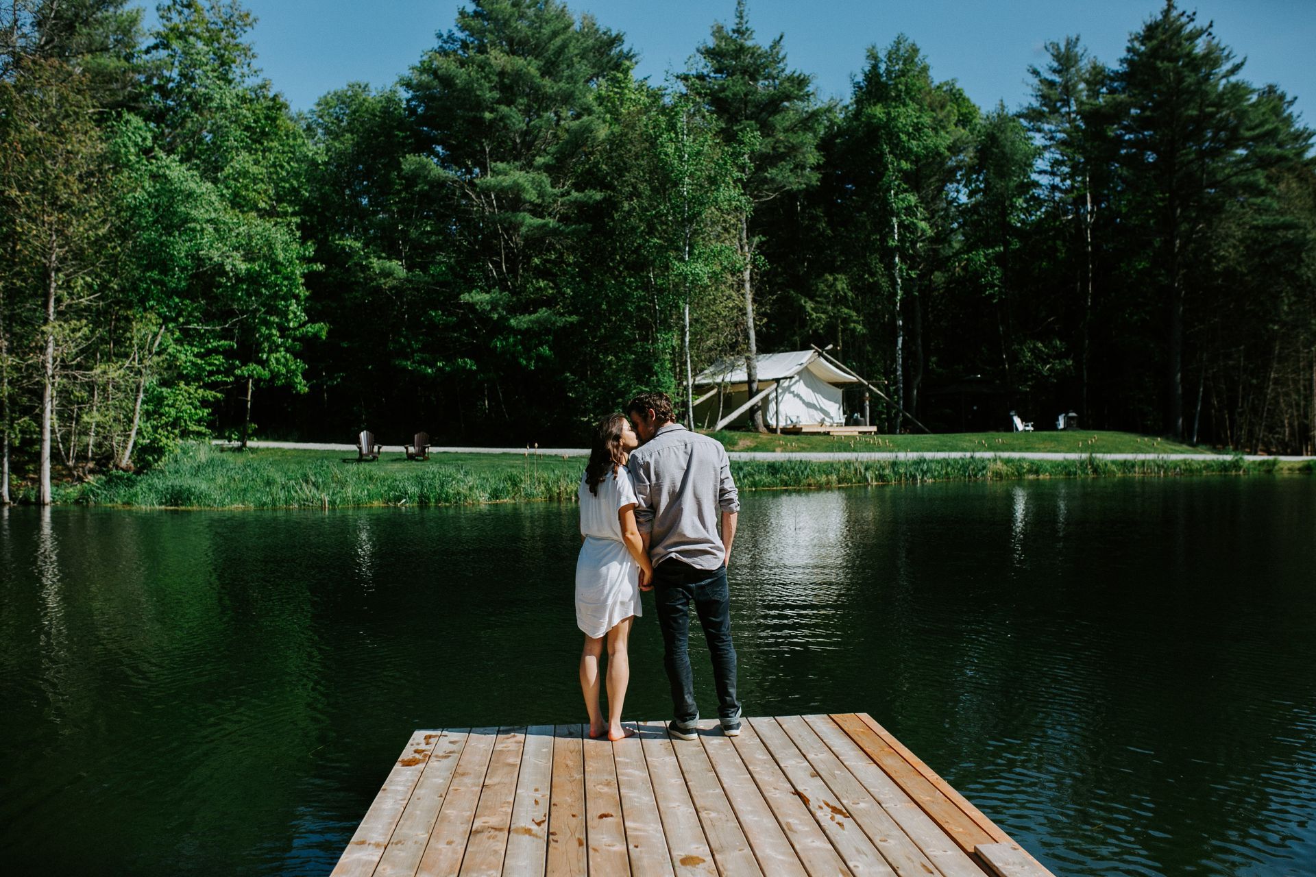 Couple stands at pond at Whispering Springs